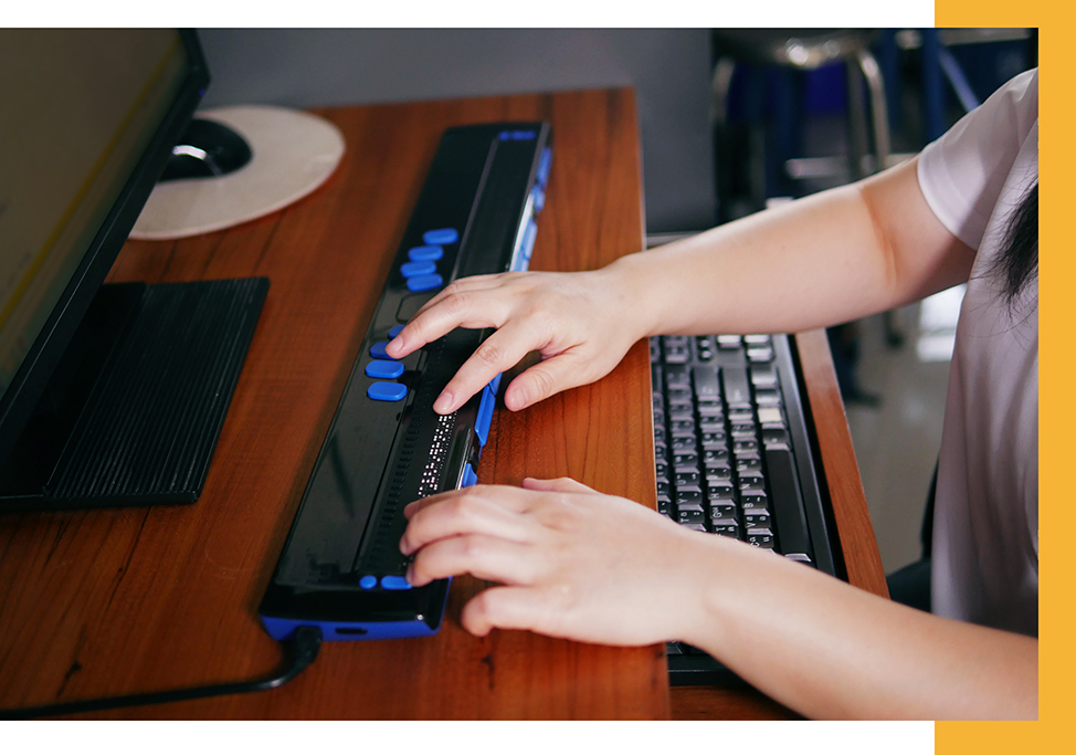 Person using an assistive device on a computer